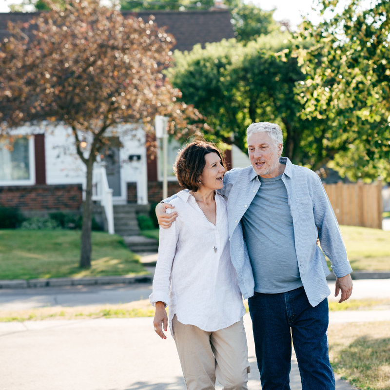 Happy couple walking together in a neighborhood