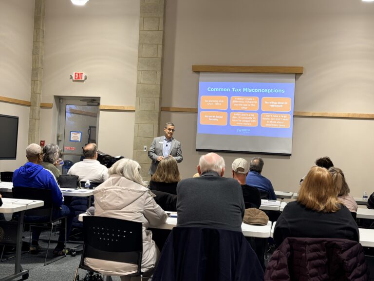 Instructor giving tax misconceptions presentation to adults
